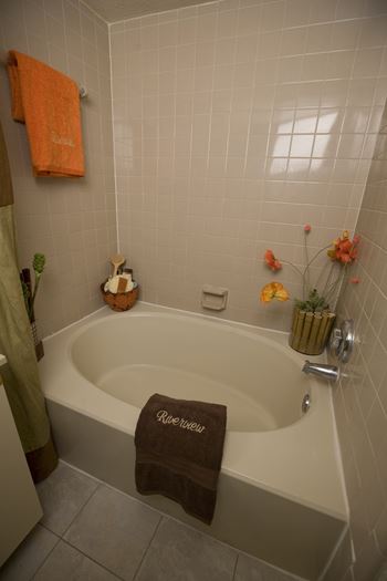 a bathroom with a bathtub and a towel on the edge of the tub